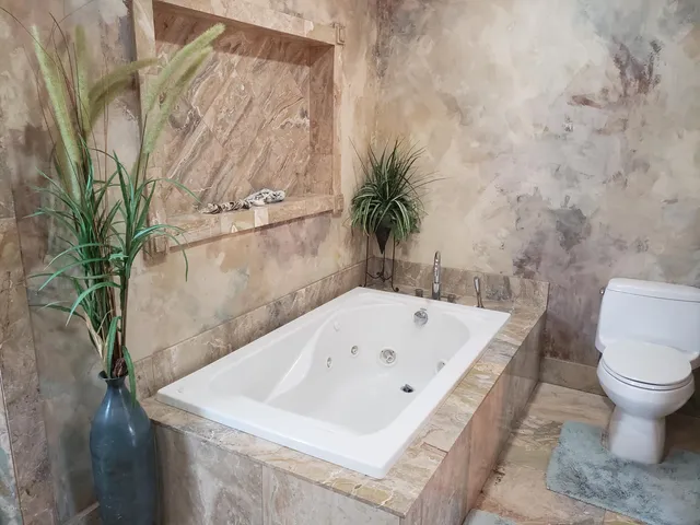 a view of patio with table and chairs and potted plants
