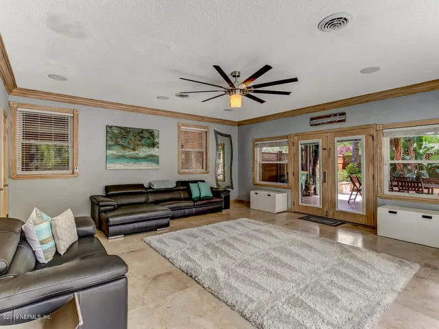 a dining room with furniture and a floor to ceiling window