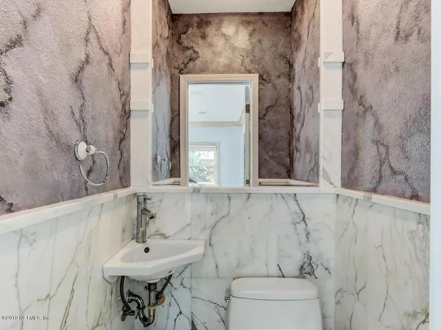 a bedroom with a bed and a flat tv screen