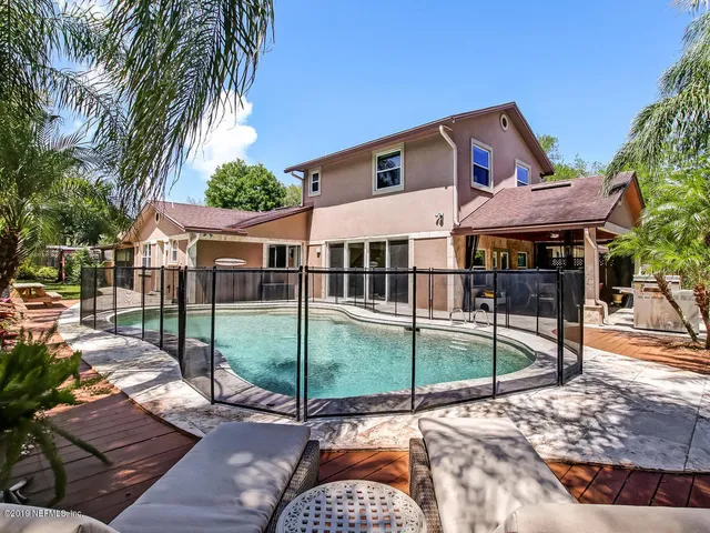 a front view of a house with a yard and a garage
