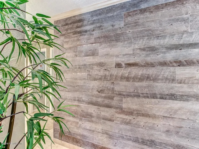 a kitchen with stainless steel appliances a refrigerator a sink a stove and white cabinets