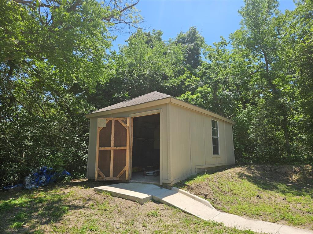 234 East Fork Road Sunnyvale, TX 75182 - Photo 19 of 32 a view of backyard with large trees and wooden fence