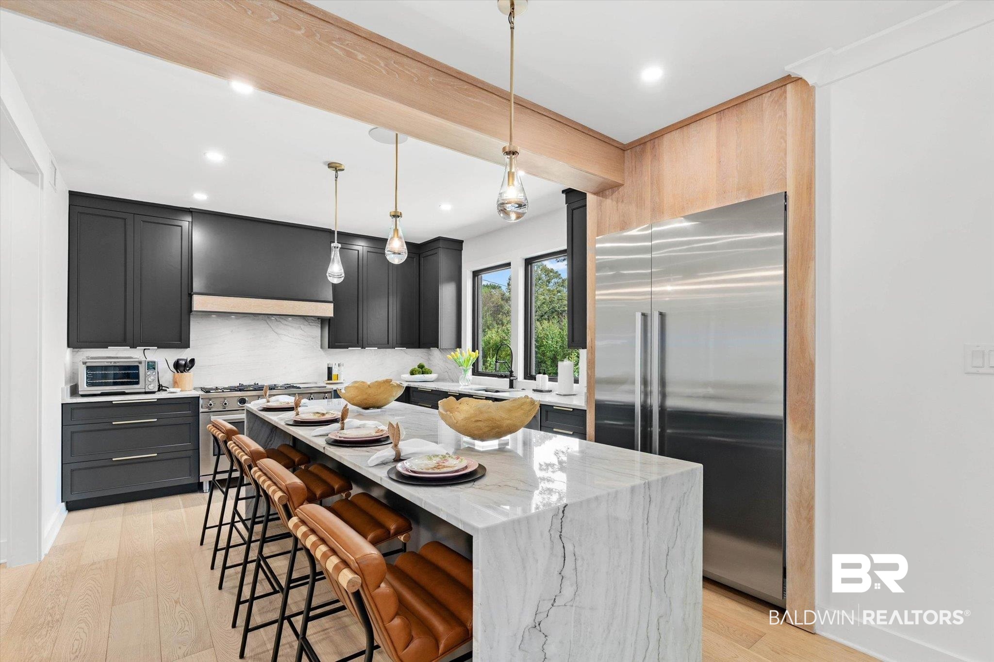 69 Jordan Lane Mobile, AL 36608 - Photo 7 of 57 Kitchen with stainless steel appliances, light stone counters, decorative light fixtures, a breakfast bar, and light wood-style floors