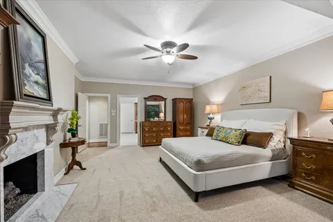 a bedroom with a bed couch and fireplace