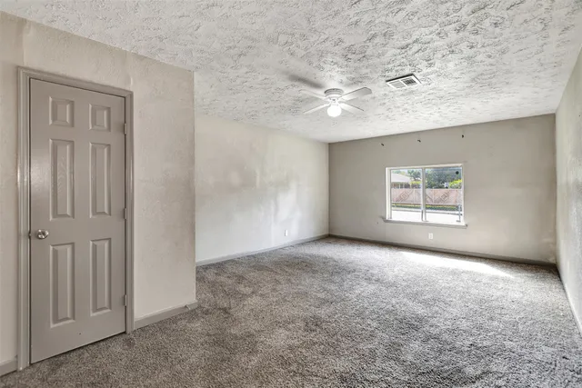 a bathroom with a granite countertop sink a mirror and a shower