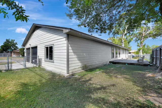 a view of backyard with a deck and wooden floor