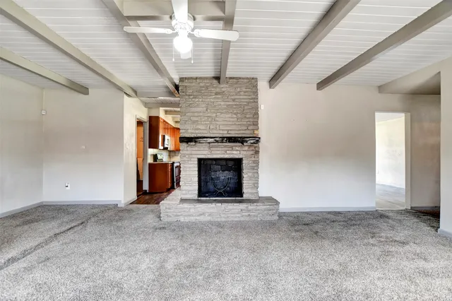 a view of an empty room with a fireplace
