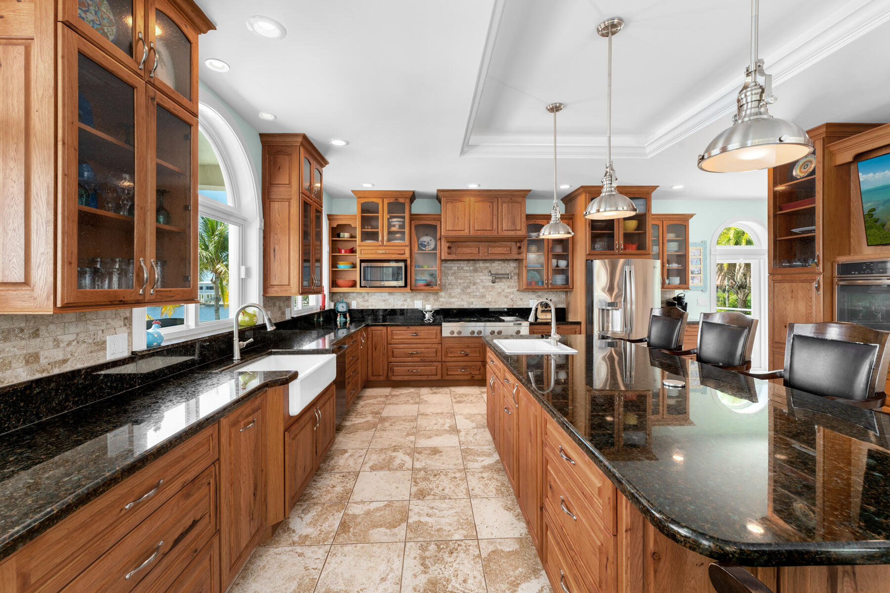 3742 Sea Grape Street Big Pine Key, FL 33043 - Photo 40 of 110 a large kitchen with stainless steel appliances kitchen island granite countertop a sink and cabinets