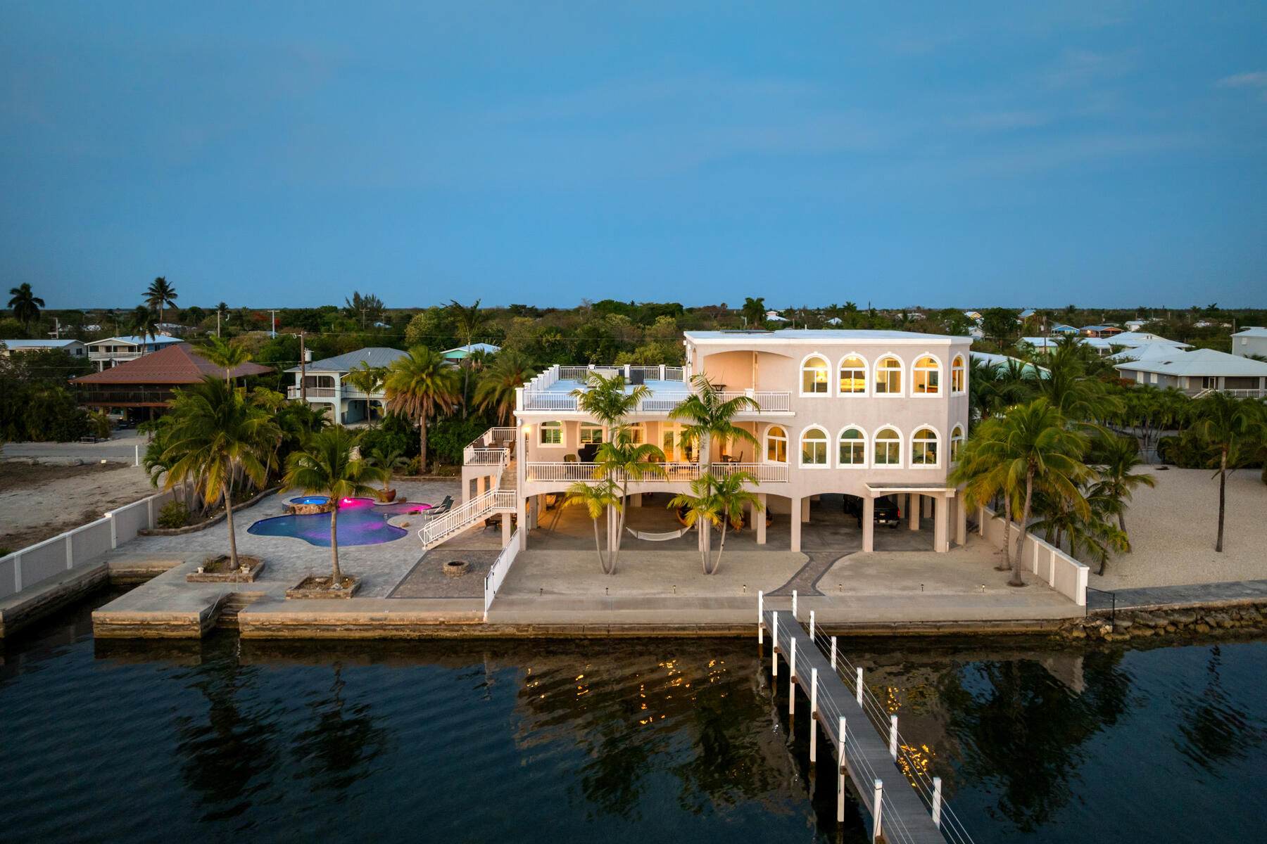 3742 Sea Grape Street Big Pine Key, FL 33043 - Photo 10 of 110 a roof deck with table and chairs with wooden floor