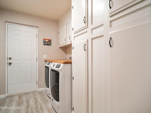 a view of a hallway with washer and dryer