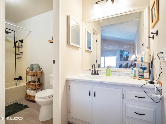 a bathroom with a sink a toilet and a mirror