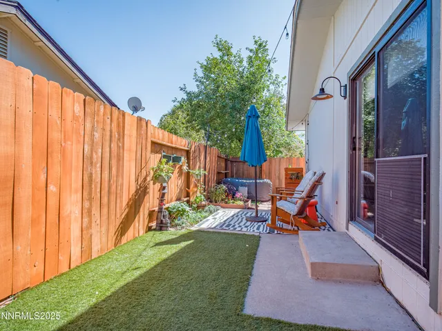 a view of backyard with a table and chairs
