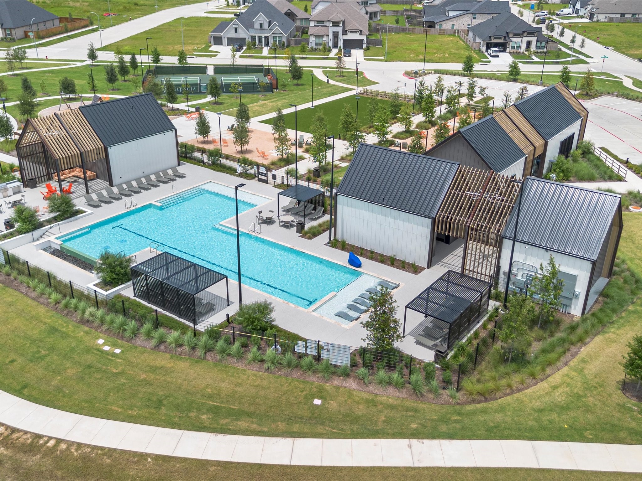 18714 Pistachio Way Manvel, TX 77578 - Photo 46 of 48 Resort-style amenities await, including a beautifully designed pool with in-water loungers, shaded cabanas, an outdoor kitchen, and an inviting clubhouse for residents to enjoy.
