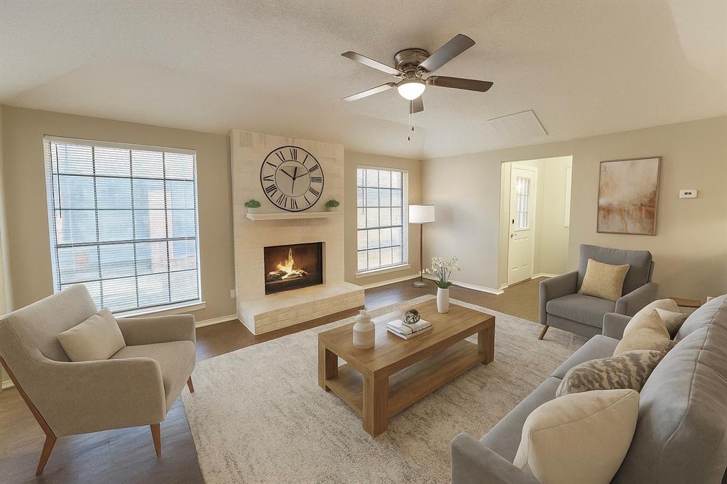 2709 Clemson Circle Rowlett, TX 75088 - Photo 1 of 6 a living room with furniture a fireplace and a large window