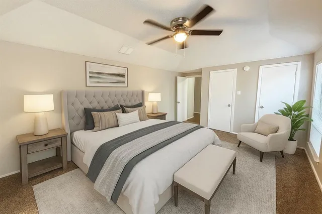 a spacious bedroom with a bed and a couch