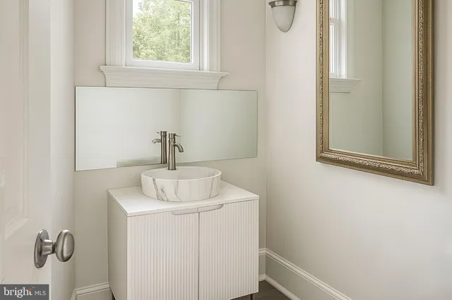 a bathroom with a sink and mirror