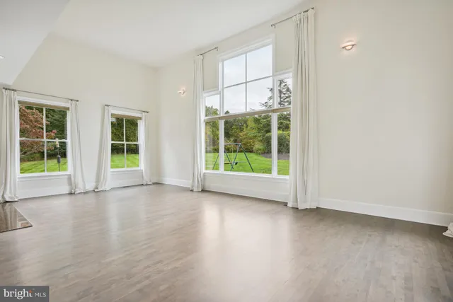 an empty room with windows and outdoor view