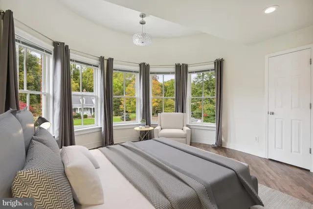 a bedroom with a large bed and a large window