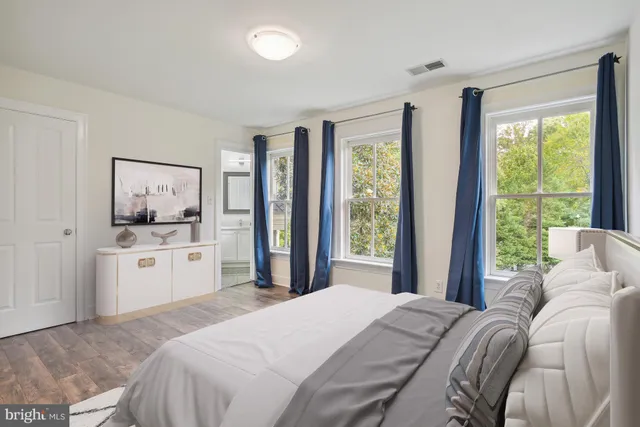 a bedroom with a large bed and a window