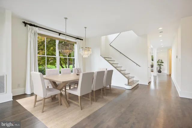 a dining room with wooden floor and a table