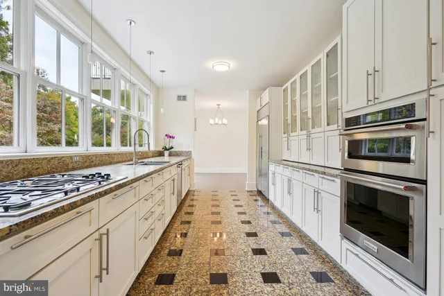 a kitchen with stainless steel appliances granite countertop a stove and a sink