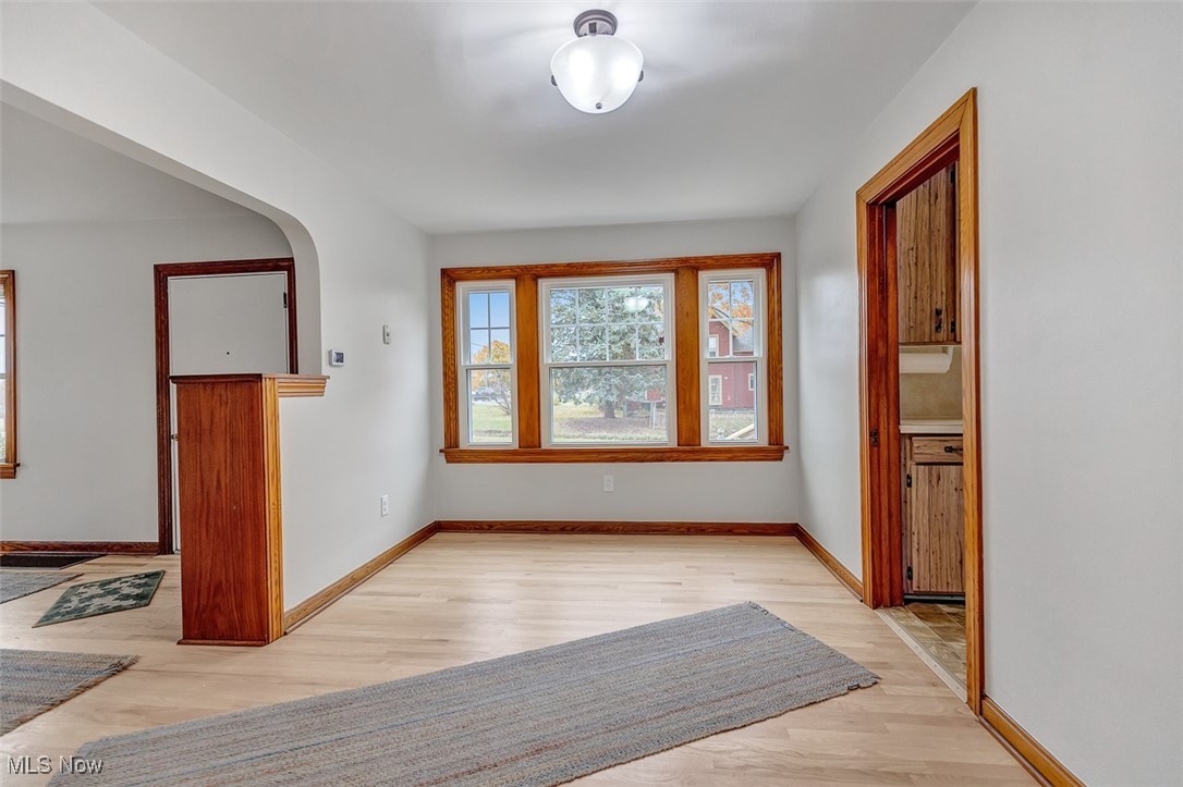 43800 Middle Ridge Road Lorain, OH 44053 - Photo 11 of 31 Unfurnished dining area with light refinished wood flooring and arched walkways, and new windows