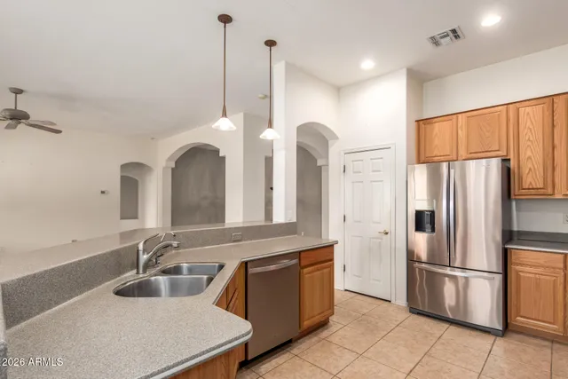 a kitchen with kitchen island granite countertop a sink stainless steel appliances and cabinets