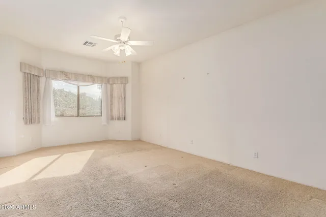 an empty room with windows and closet