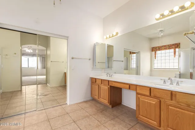a large bathroom with a sink a mirror and a shower