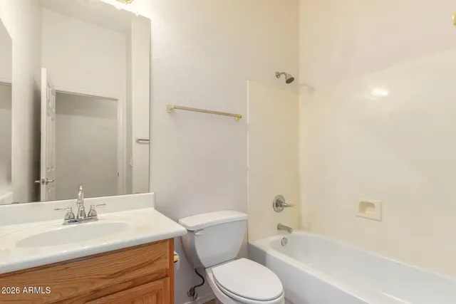 a bathroom with a granite countertop toilet a sink and a bathtub