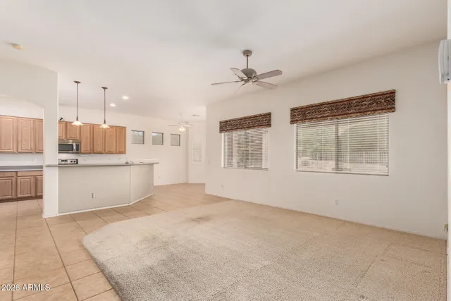 a view of an empty room with a kitchen
