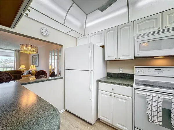 a kitchen with cabinets and wooden floor