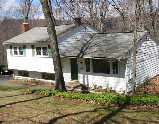 39 Virginia Court Ridgefield, CT 06877 - Photo 1 of 1 a front view of a house with garden