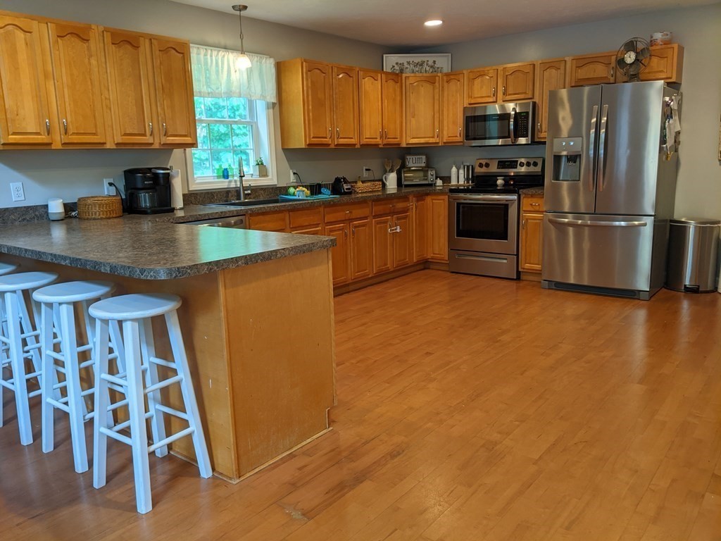 1230 Bemis Road Warren, MA 01083 - Photo 2 of 17 a kitchen with granite countertop a refrigerator stove and sink