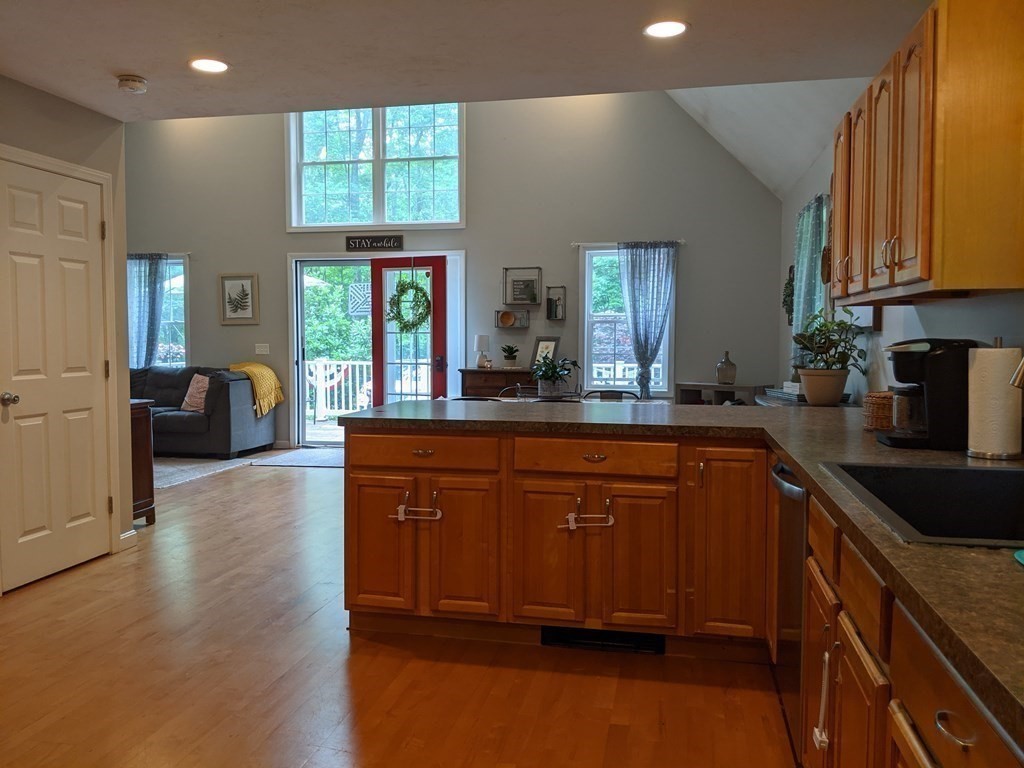 1230 Bemis Road Warren, MA 01083 - Photo 4 of 17 a kitchen with stainless steel appliances granite countertop wooden cabinets a stove a sink a window and a refrigerator