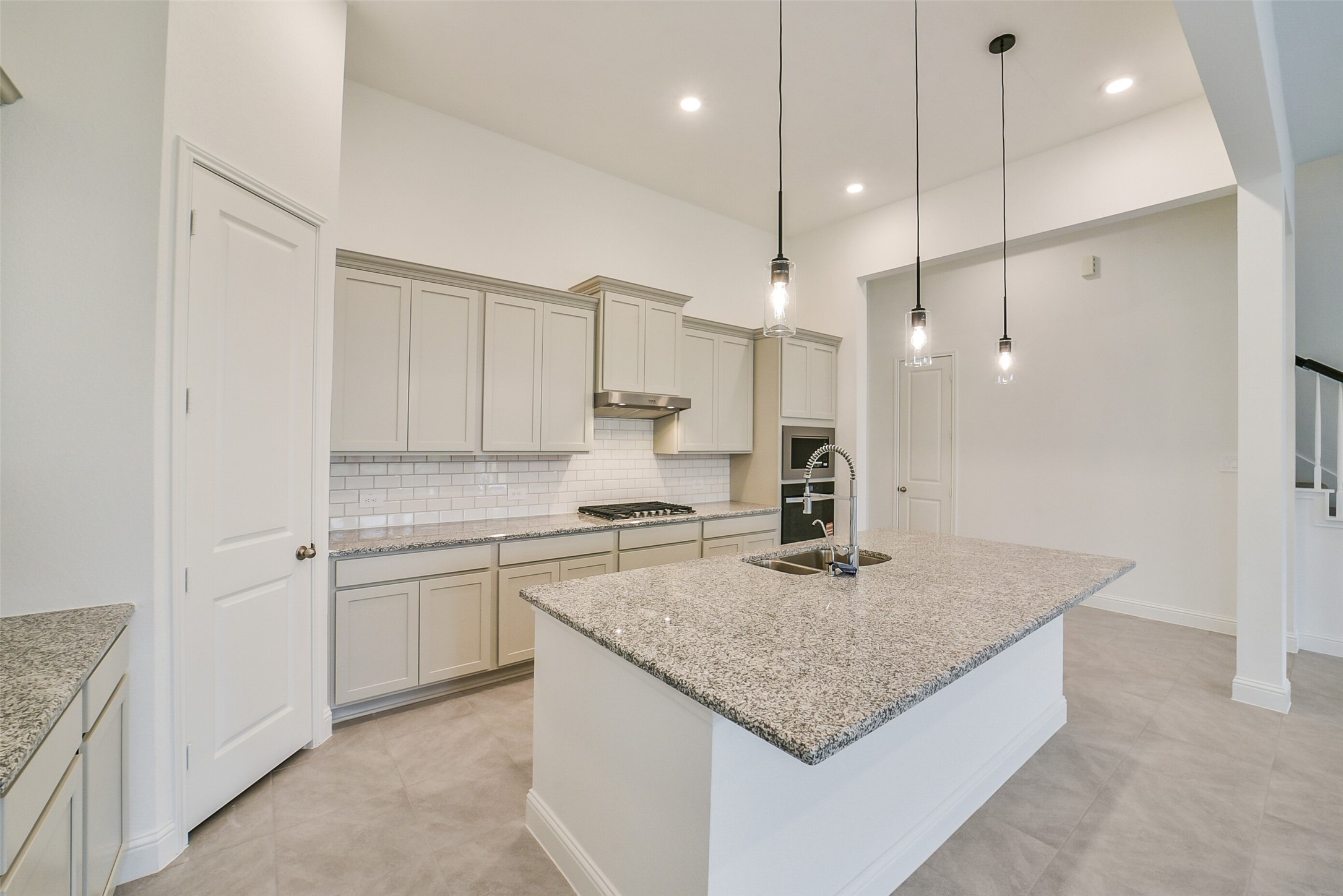 16018 Tangled Vine Lane Conroe, TX 77302 - Photo 12 of 41 a kitchen with stainless steel appliances granite countertop stove top oven and refrigerator