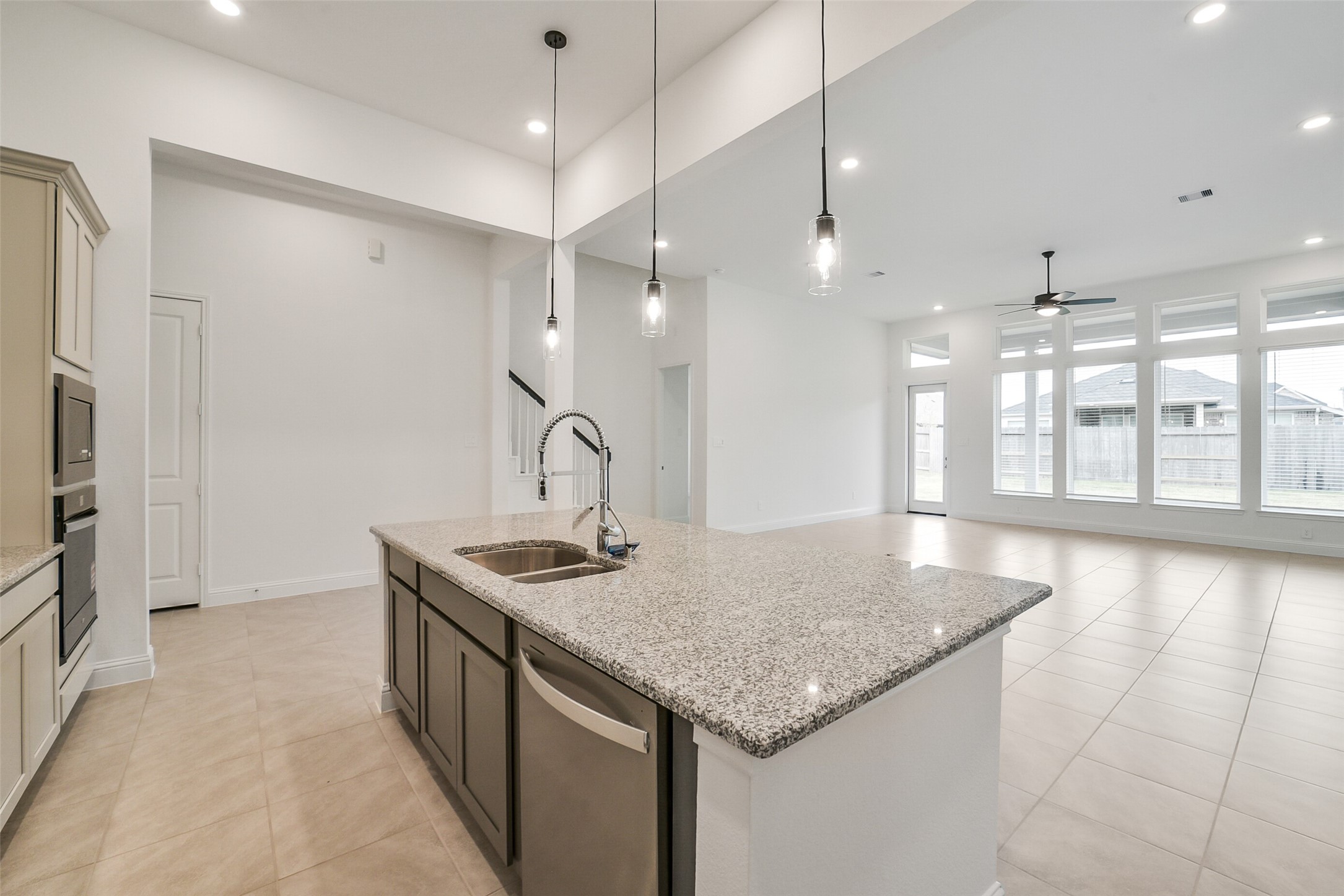 16018 Tangled Vine Lane Conroe, TX 77302 - Photo 13 of 41 a kitchen with stainless steel appliances granite countertop a sink and a refrigerator