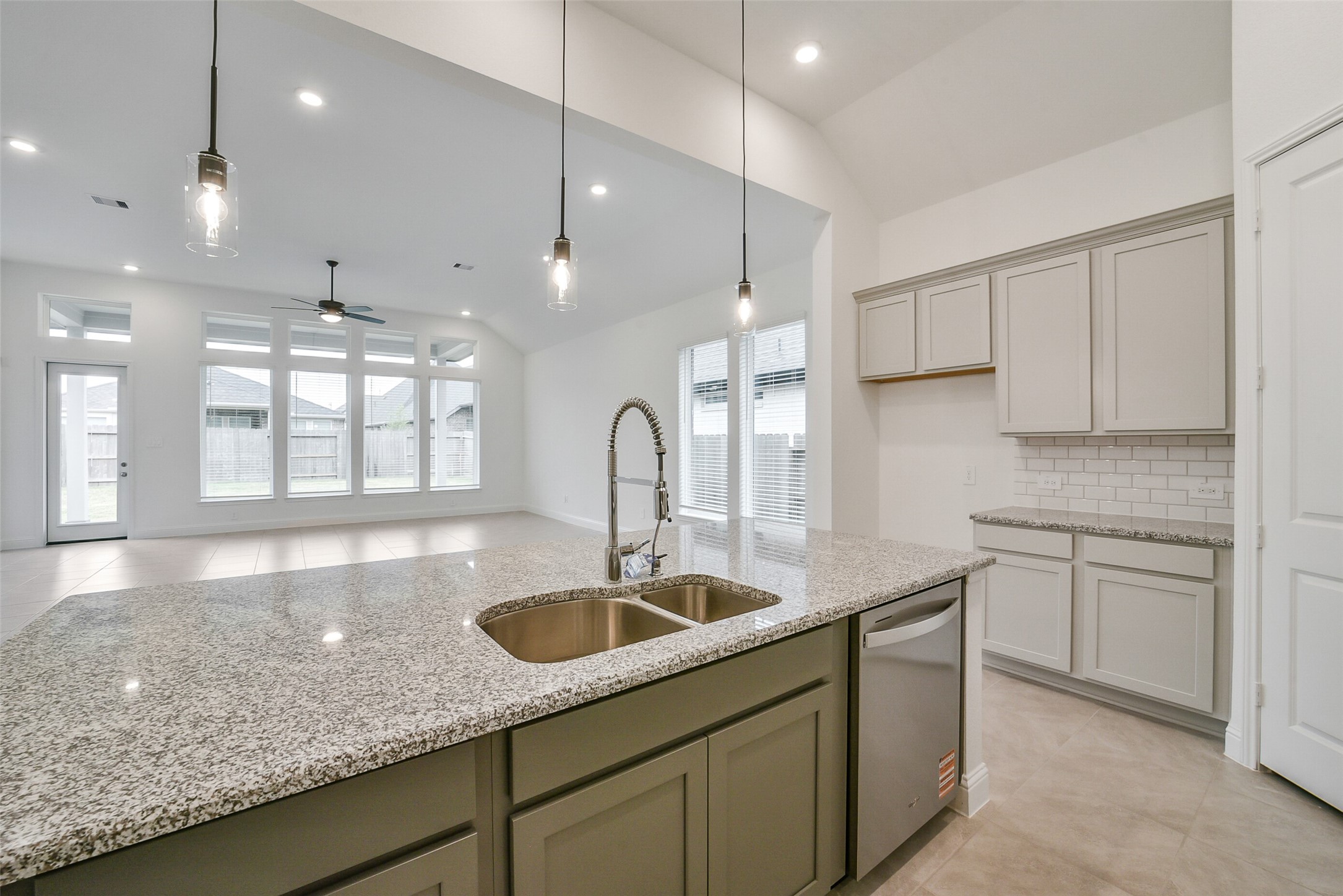 16018 Tangled Vine Lane Conroe, TX 77302 - Photo 15 of 41 a kitchen with kitchen island granite countertop a sink white cabinets and stainless steel appliances