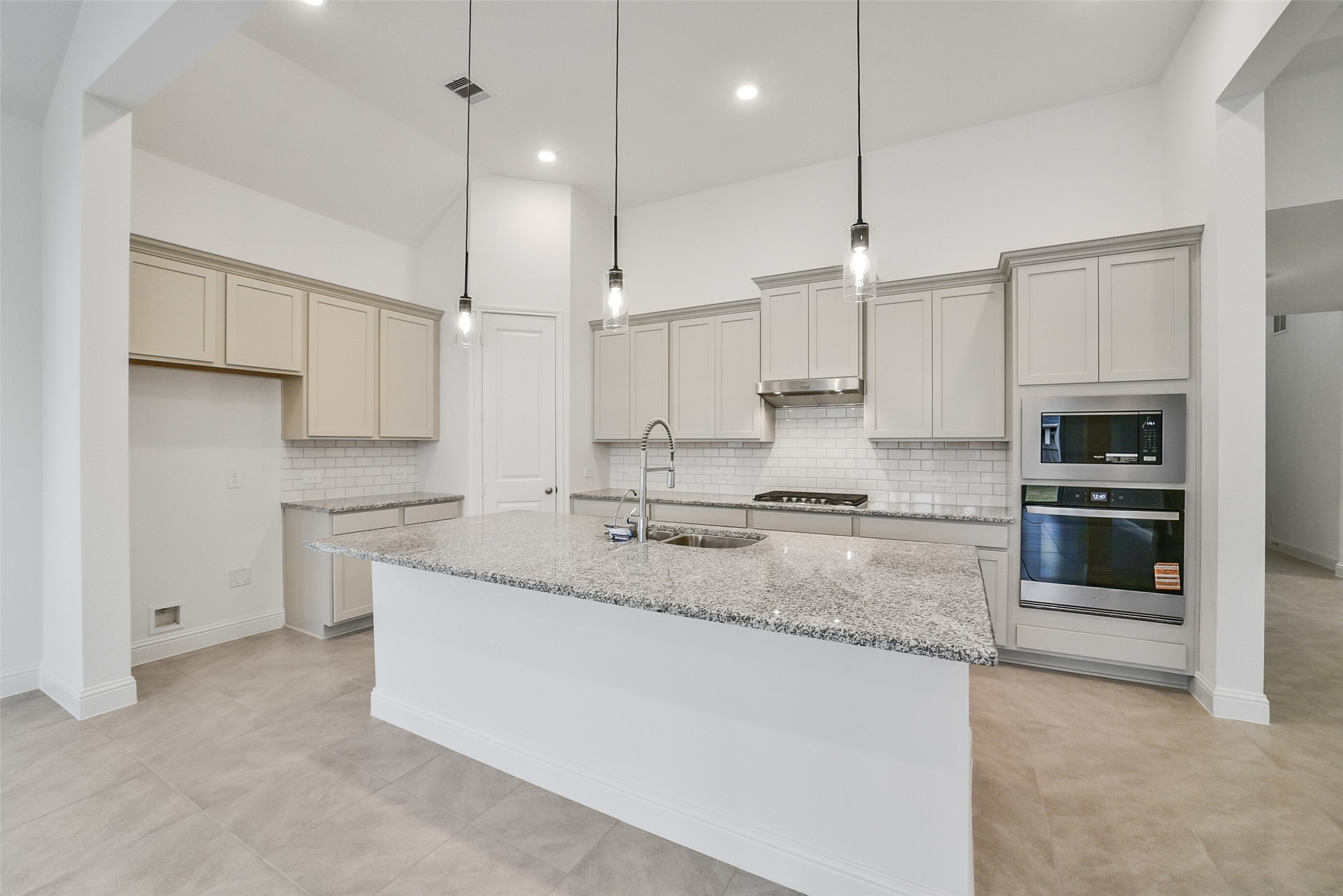 16018 Tangled Vine Lane Conroe, TX 77302 - Photo 17 of 41 a kitchen with stainless steel appliances granite countertop a sink a stove and a refrigerator