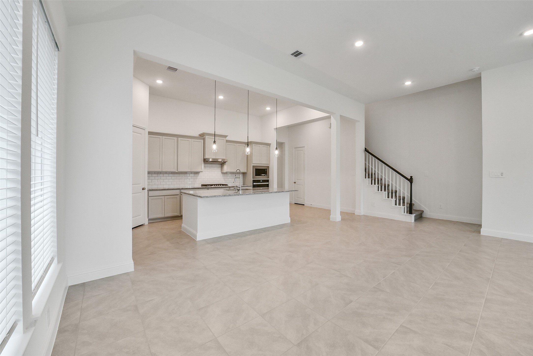 16018 Tangled Vine Lane Conroe, TX 77302 - Photo 19 of 41 a view of a kitchen with white cabinets and stainless steel appliances