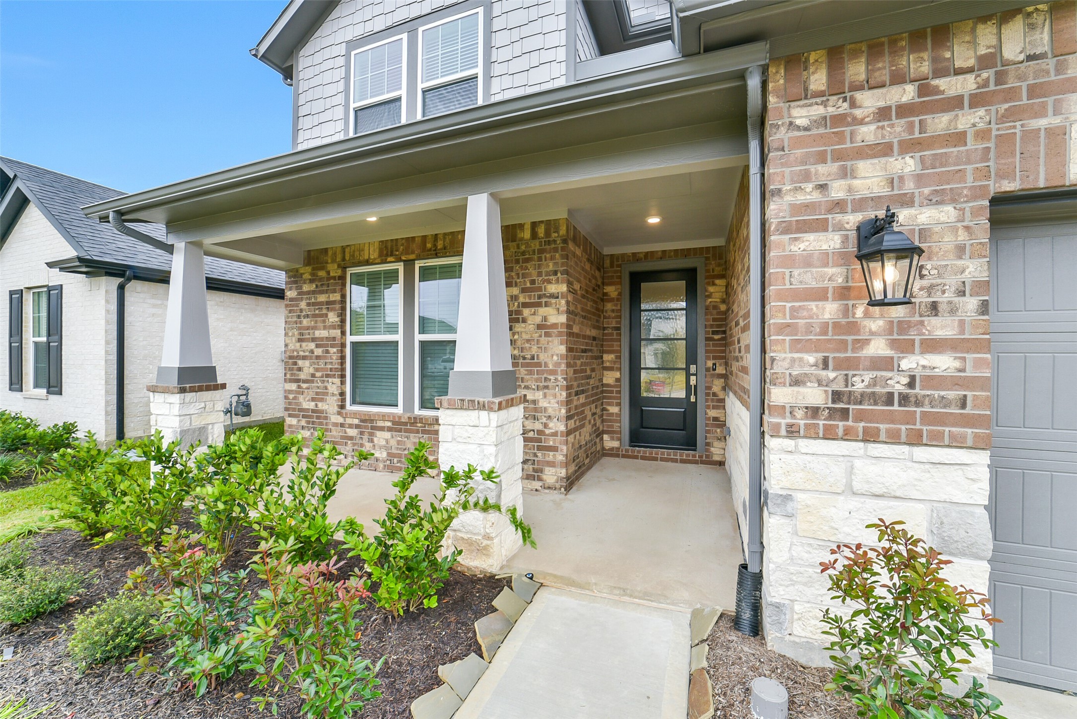 16018 Tangled Vine Lane Conroe, TX 77302 - Photo 2 of 41 front view of a brick building with a large window
