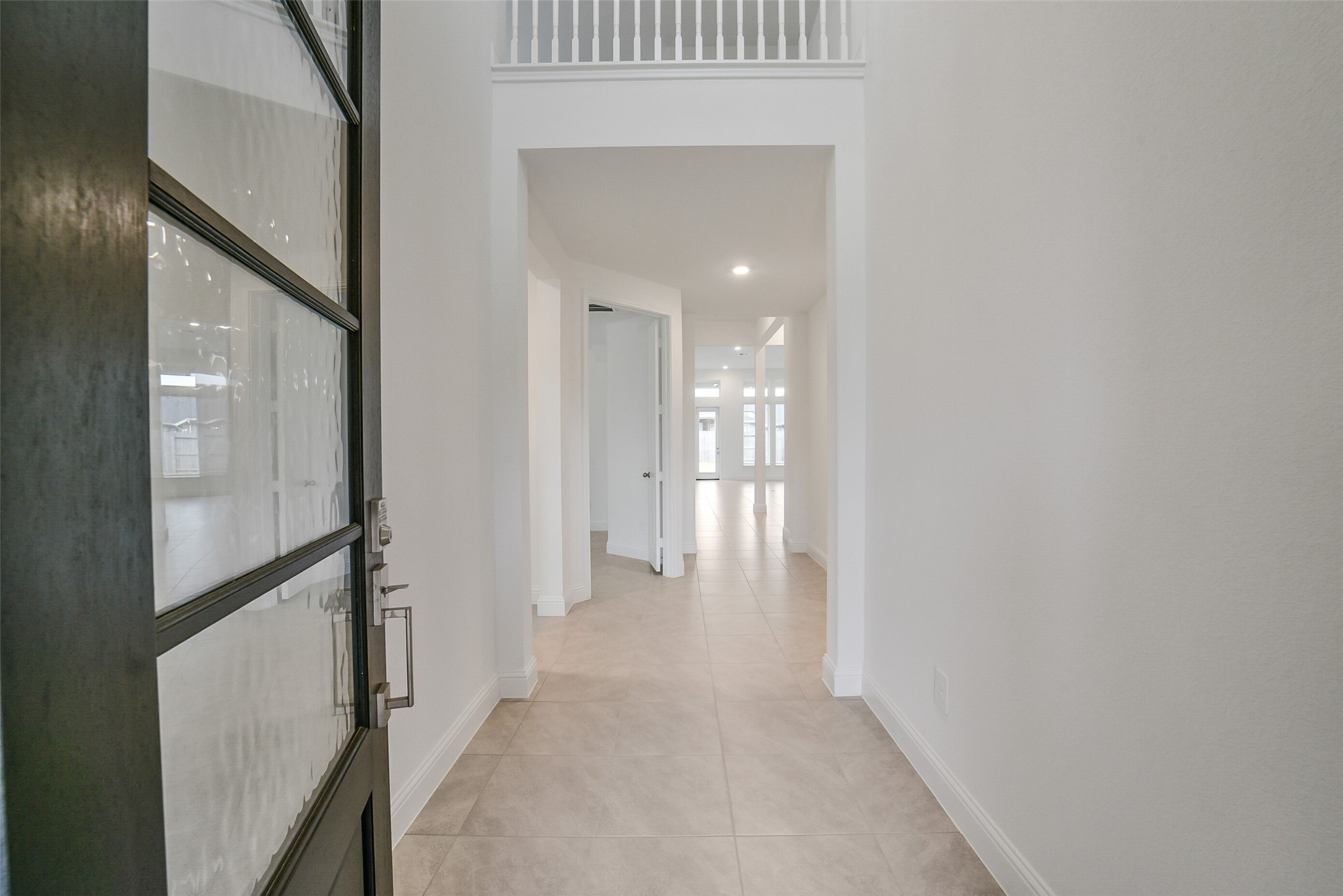 16018 Tangled Vine Lane Conroe, TX 77302 - Photo 3 of 41 a view of a hallway with wooden floor and staircase