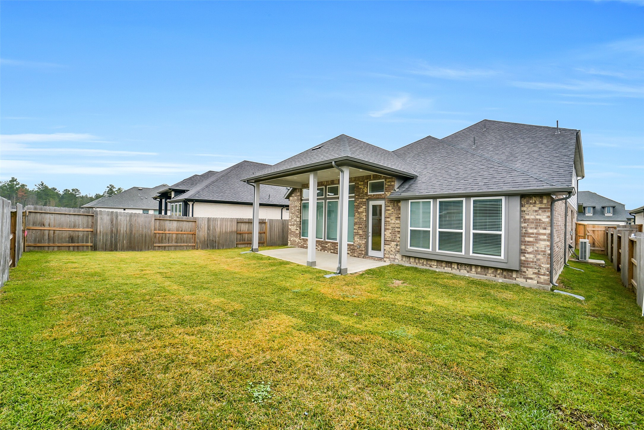 16018 Tangled Vine Lane Conroe, TX 77302 - Photo 39 of 41 a view of a house with a yard and sitting area