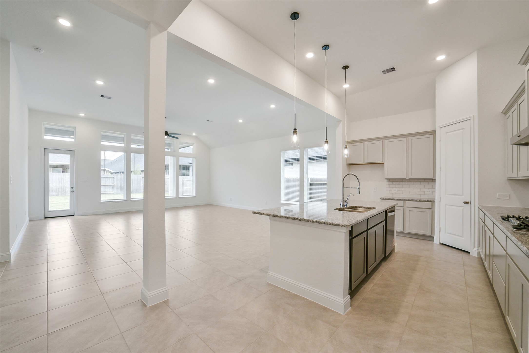 16018 Tangled Vine Lane Conroe, TX 77302 - Photo 7 of 41 a kitchen with stainless steel appliances granite countertop a stove top oven a sink and a refrigerator