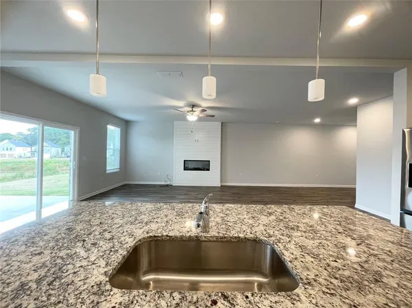 a bathroom with a sink a large mirror and vanity