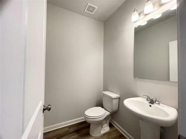 a bathroom with a sink a toilet and mirror