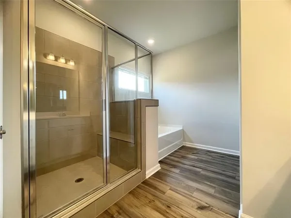a spacious bathroom with a double vanity sink a mirror and a shower