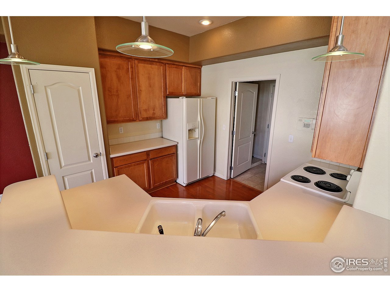 5600 West 3rd Street, Unit 4 Greeley, CO 80634 - Photo 11 of 32 a bedroom with a bed and a chandelier