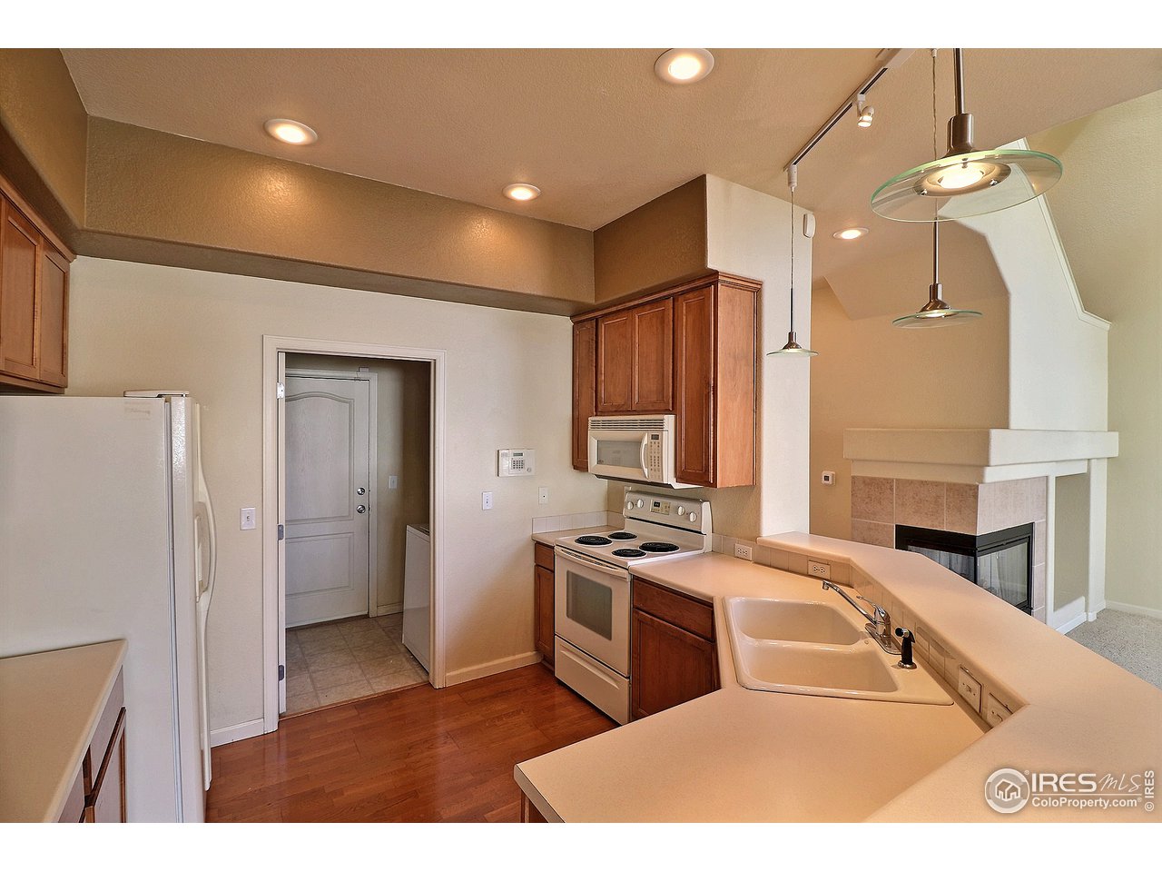5600 West 3rd Street, Unit 4 Greeley, CO 80634 - Photo 13 of 32 a open kitchen with stainless steel appliances granite countertop a sink a stove and a refrigerator