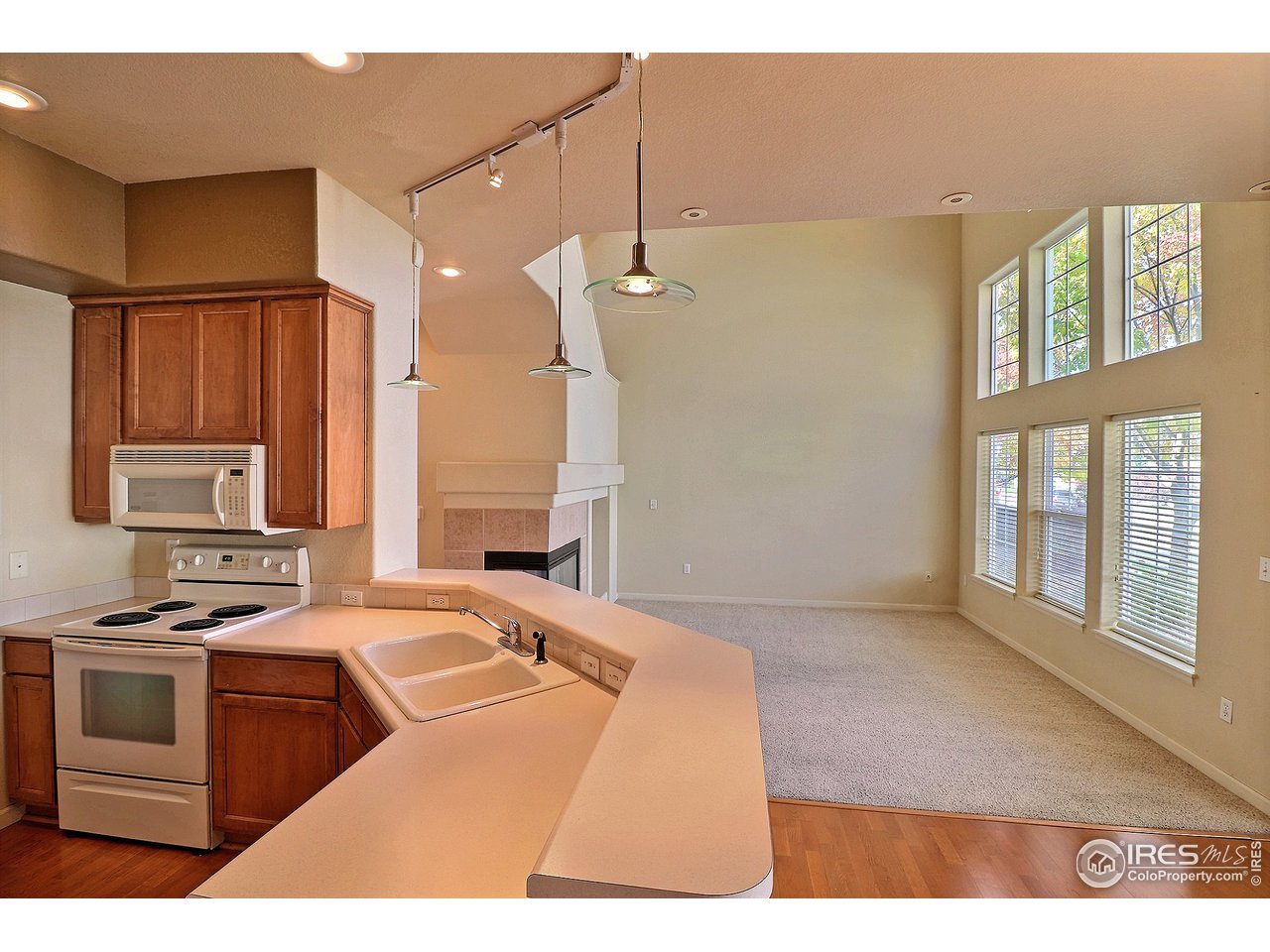 5600 West 3rd Street, Unit 4 Greeley, CO 80634 - Photo 14 of 32 a kitchen with a stove a sink and a window